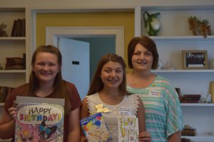 : Carolyn Lang, along with 4-H members Anna and Caroline Whisonant delivered birthday party supplies to our Ruston campus.